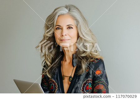 Busy middle aged business woman executive using laptop working in office. 117070029