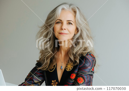 Busy middle aged business woman executive using laptop working in office. 117070030