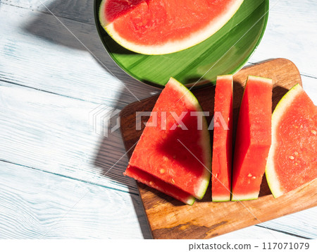 Watermelon slices on wooden cutting board, summer fruit Watermelon slices on wooden cutting board, summer fruit 117071079