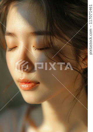 Closeup of young woman serene face Thai massage natural light magazine style 117071461
