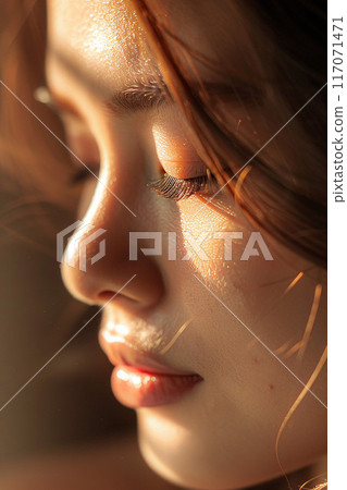Closeup of relaxed woman's face Thai massage sunlight streaming elegant spa 117071471