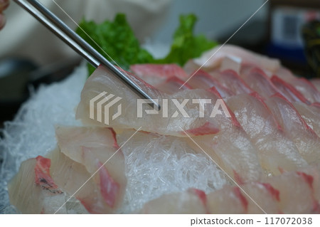 Raw fresh fish sashimi with chopsticks Raw fresh fish sashimi with chopsticks 117072038
