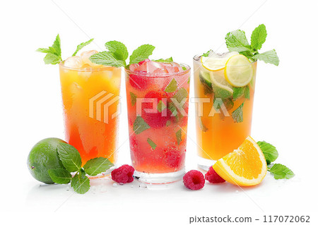 Refreshing summer juices on white background, garnished with mint leaves Refreshing summer juices on white background, garnished with mint leaves 117072062