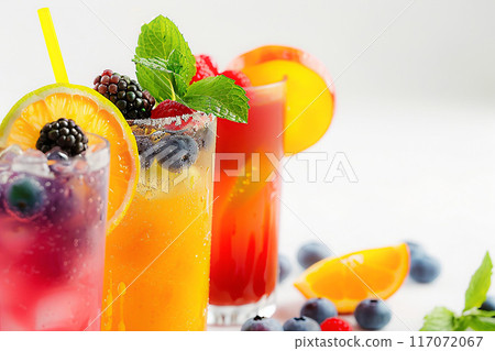 Summer juices on white background, colorful fruit garnishes, chilled and delicious 117072067