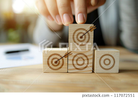 Concept of business growth, woman hand stacking wood blocks with target icon, office desk, High resolution Concept of business growth, woman hand stacking wood blocks with target icon, office desk, High resolution 117072551