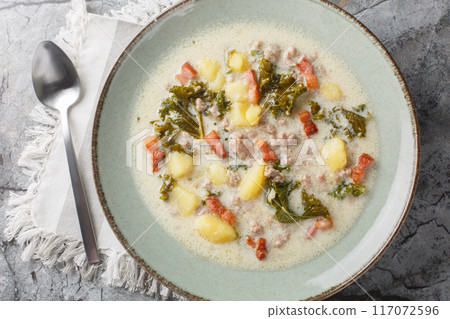 Homemade Warm Creamy Tuscan Soup with Sausage and Kale closeup on the plate. Horizontal top view Homemade Warm Creamy Tuscan Soup with Sausage and Kale closeup on the plate. Horizontal top view 117072596