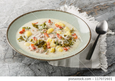 Traditional Zuppa Toscana or Tuscan Soup with Italian sausage, kale, fried bacon and potatoes closeup on the plate. Horizontal Traditional Zuppa Toscana or Tuscan Soup with Italian sausage, kale, fried bacon and potatoes closeup on the plate. Horizontal 117072601