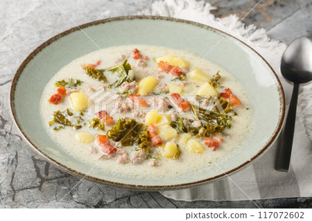 Homemade Warm Creamy Tuscan Soup with Sausage and Kale closeup on the plate. Horizontal Homemade Warm Creamy Tuscan Soup with Sausage and Kale closeup on the plate. Horizontal 117072602