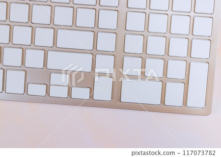 Computer keyboard with blank buttons is white without any inscriptions Computer keyboard with blank buttons is white without any inscriptions 117073782