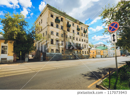 An Urban Landscape showcasing a Historic Building alongside a prominent Street Sign in the city An Urban Landscape showcasing a Historic Building alongside a prominent Street Sign in the city 117073943