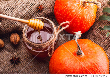 The Beautiful Autumn Harvest Featuring Sweet Honey and Pumpkins Set Against a Rustic Background The Beautiful Autumn Harvest Featuring Sweet Honey and Pumpkins Set Against a Rustic Background 117073947