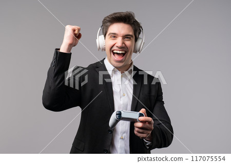 Excited Gamer BusinessMan Playing, Winning Online Video Game Console Joystick Excited Gamer BusinessMan Playing, Winning Online Video Game Console Joystick 117075554