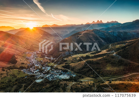 Sunrise over Arves massif among French Alps with ski town in valley during autumn 117075639