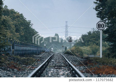 Train track, metal railway with rail switching and signboard pole at station Train track, metal railway with rail switching and signboard pole at station 117075682