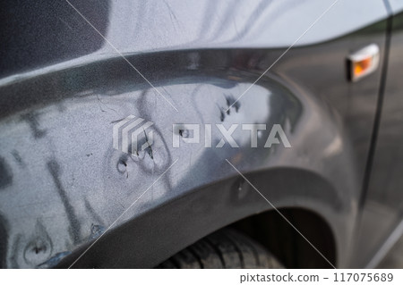 Scratched and damaged on metal part of grey car around wheel arch 117075689