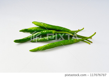 Green chili peppers on white background (with copy space) Green chili peppers on white background (with copy space) 117076787