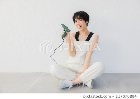 A woman with short hair doing DIY A woman with short hair doing DIY 117076894