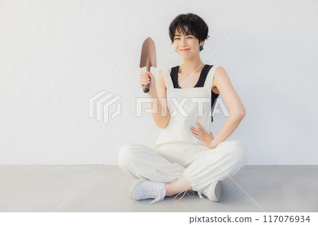 A woman with short hair doing DIY A woman with short hair doing DIY 117076934
