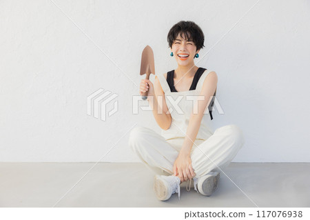 A woman with short hair doing DIY A woman with short hair doing DIY 117076938