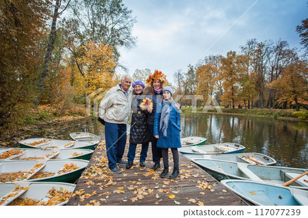 Multi Generation Family near lake on autumn pier Multi Generation Family near lake on autumn pier 117077239