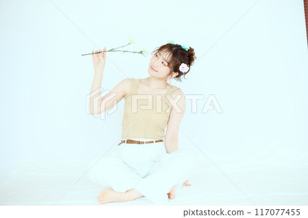 Port of a woman holding colorful carnations 117077455