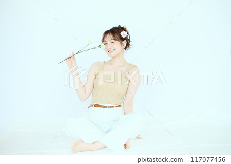 Port of a woman holding colorful carnations Port of a woman holding colorful carnations 117077456