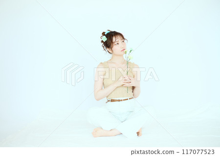 Port of a woman holding colorful carnations 117077523