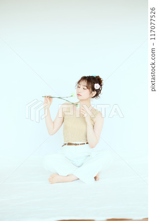 Port of a woman holding colorful carnations 117077526