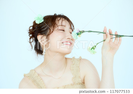 Port of a woman holding colorful carnations 117077533