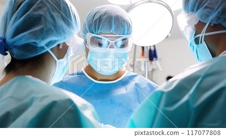 Surgical team in the operating room performing surgery on a patient. Medical professionals working together during a surgical procedure. 117077808