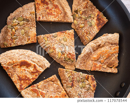 Closeup of homemade protein keto bread in skillet outdoors Closeup of homemade protein keto bread in skillet outdoors 117078544
