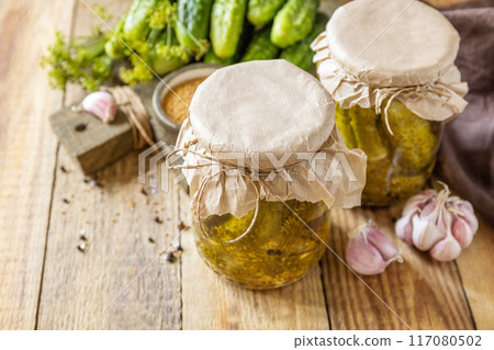 Healthy homemade fermented food. Salted pickled cucumbers with mustard preserved canned in glass jar. Home economics, autumn harvest preservation. Copy space. Healthy homemade fermented food. Salted pickled cucumbers with mustard preserved canned in glass jar. Home economics, autumn harvest preservation. Copy space. 117080502
