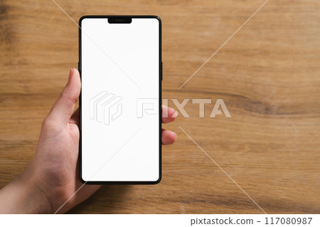 young man hand holding smartphone with blank white screen 117080987
