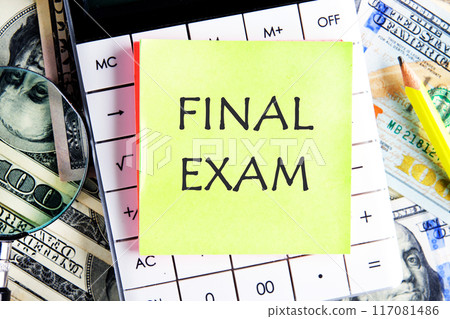 Conceptual final exam symbol. Copy space. Final exam message written a concept phrase on a yellow sticker on a calculator on dollar bills 117081486
