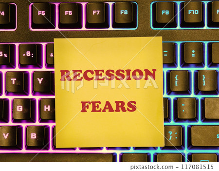 Business and recession fears concept. Copy space. Recession fears symbol. Concept words Recession on a yellow sticker on the background of a backlit keyboard 117081515