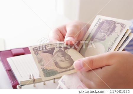 Woman's hands counting money Woman's hands counting money 117081925