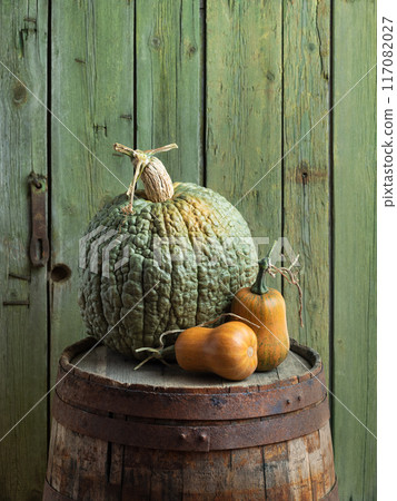 Crespo Squash and Butternut Pumpkins on a Rustic Barrel Crespo Squash and Butternut Pumpkins on a Rustic Barrel 117082027