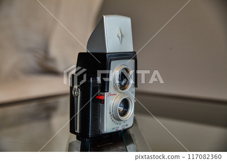 Vintage Brownie Starflex Camera on Reflective Surface, Close-Up Angle Vintage Brownie Starflex Camera on Reflective Surface, Close-Up Angle 117082360