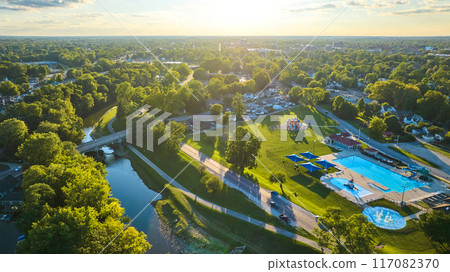 Tuhey Pool aerial with neighborhood beside White River on sunny late afternoon, Muncie IN 117082370