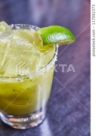 Refreshing Margarita Cocktail with Lime and Salt, Eye-Level View Refreshing Margarita Cocktail with Lime and Salt, Eye-Level View 117082373