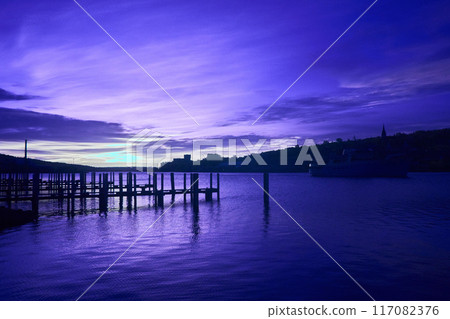 Twilight Waterfront with Pier and Moored Boat, Reflections on Calm Water Infrared Twilight Waterfront with Pier and Moored Boat, Reflections on Calm Water Infrared 117082376