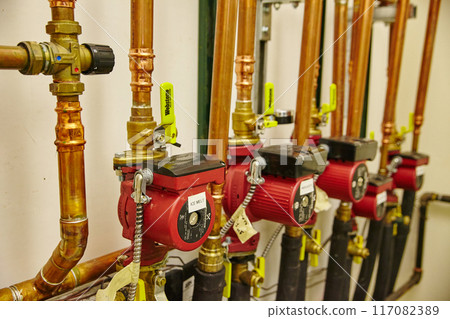 Industrial Pumps and Copper Piping in Mechanical Room Industrial Pumps and Copper Piping in Mechanical Room 117082389