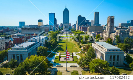 Aerial View of Urban Park with American Flag and City Skyline 117082422