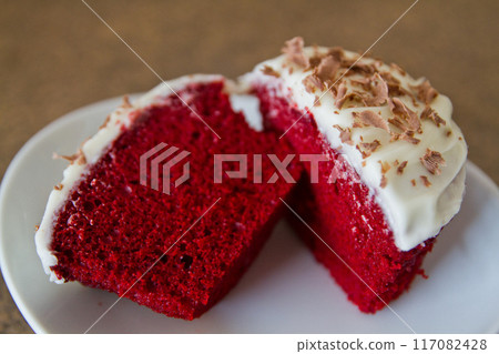 Red Velvet Cupcake with Cream Cheese Frosting and Chocolate Shavings Close-Up 117082428