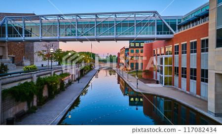 Aerial Twilight Urban with Modern Pedestrian Bridge and Canal Reflections 117082434