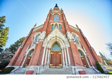 Gothic Red-Brick Church with Stained Glass, Clear Blue Sky Low Angle View 117082457