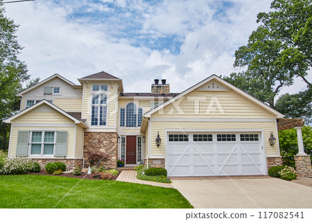 Classic American Suburban Home with Manicured Lawn and Pathway Classic American Suburban Home with Manicured Lawn and Pathway 117082541
