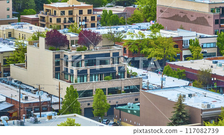 Aerial View of Modern and Historic Buildings with Lush Greenery in Downtown Bend 117082739