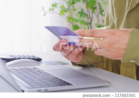A man checking the contents of his savings passbook 117083301