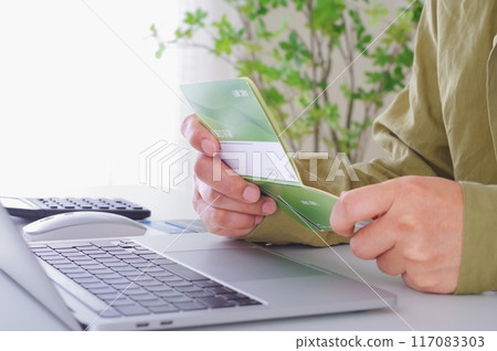 A man checking the contents of his savings passbook A man checking the contents of his savings passbook 117083303